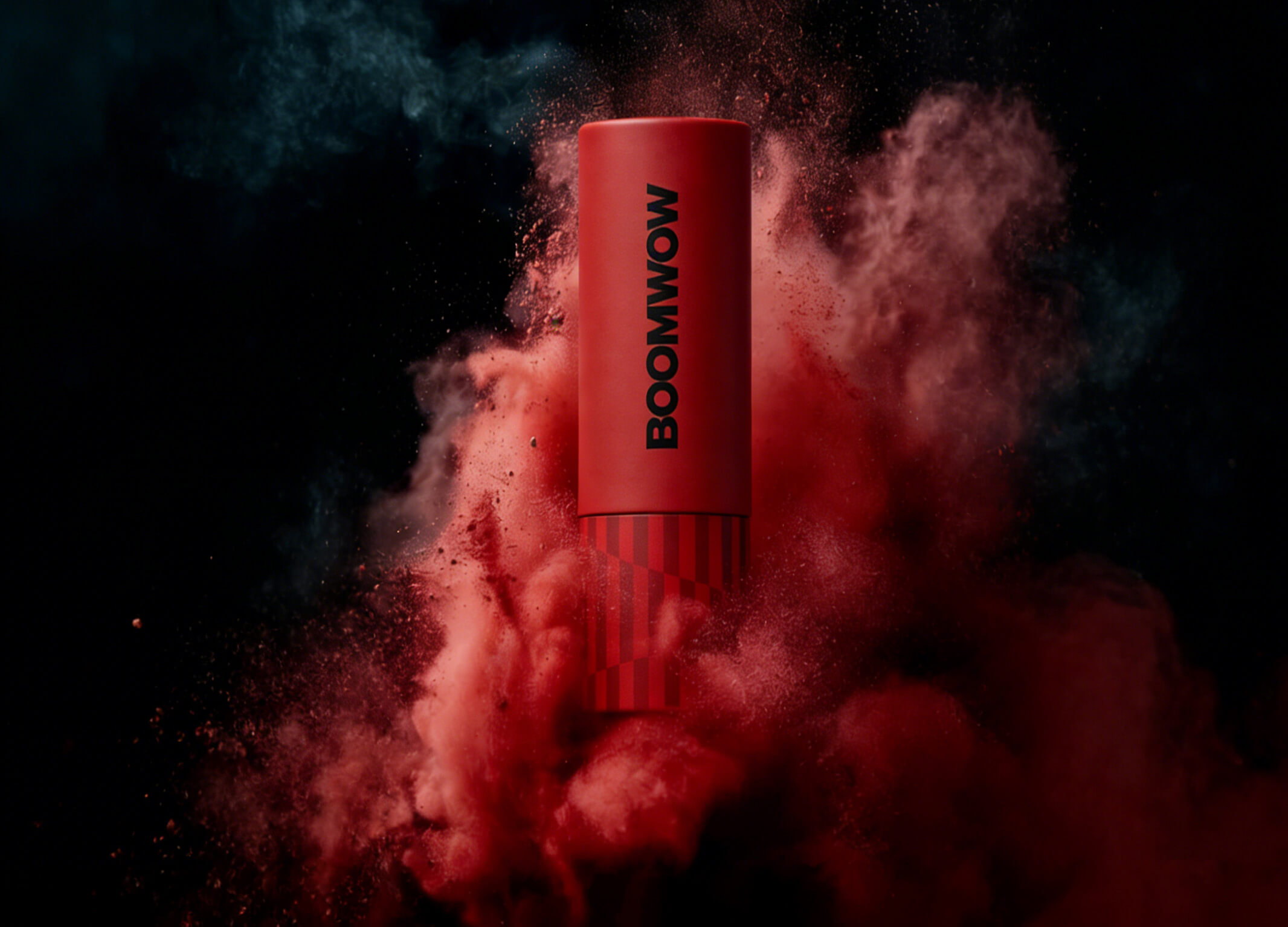 A red BOOMWOW popper surrounded by a dramatic burst of colored powder