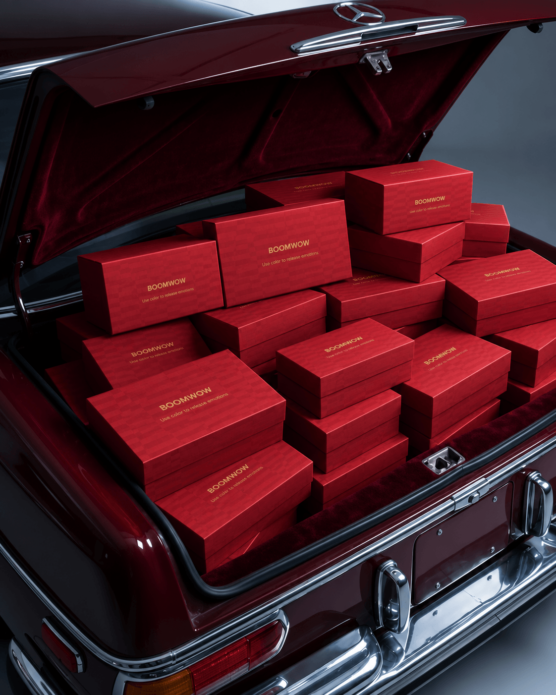BOOMWOW gift boxes arranged in the trunk of a classic red car